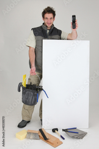 Photo: Man advertising his tiling services Man advertising his tiling services
