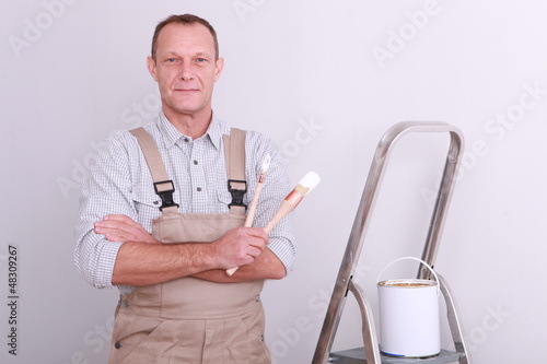 Photo: Painter with brush in hand Painter with brush in hand