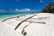 Wooden boat on tropical beach with white sand