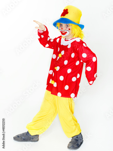 Photo: Funny child as a clown deancing in a carnival costume Funny child as a clown deancing in a carnival costume