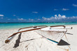 Wooden boat on tropical beach with white sand