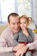 Photo: Happy father and daughter at home smiling Happy father and daughter at home smiling