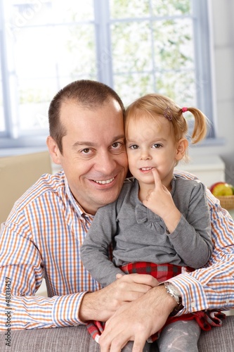 Photo: Happy father and daughter at home smiling Happy father and daughter at home smiling