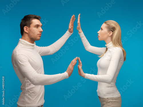 Photo: man and woman working with something imaginary man and woman working with something imaginary