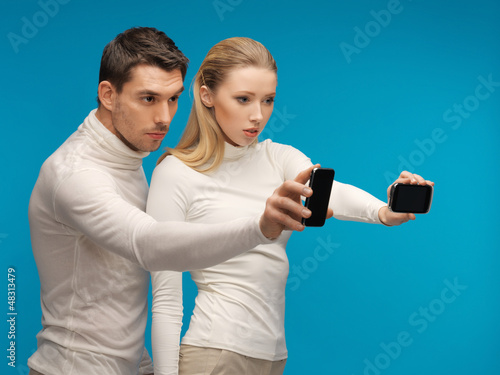 Photo: man and woman with modern gadgets man and woman with modern gadgets