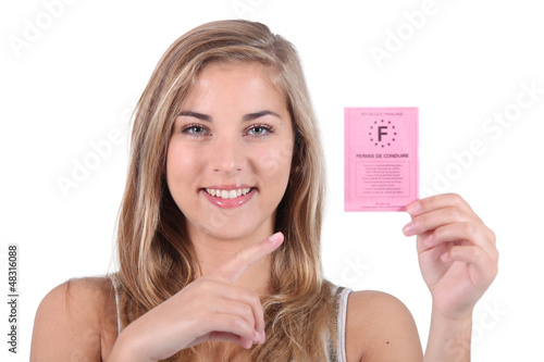 Photo: Teenager holding to driving license Teenager holding to driving license