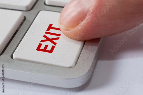 Photo: Finger pressing EXIT key Finger pressing EXIT key