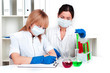 Foto: women chemists conduct experiments in the laboratory women chemists conduct experiments in the laboratory