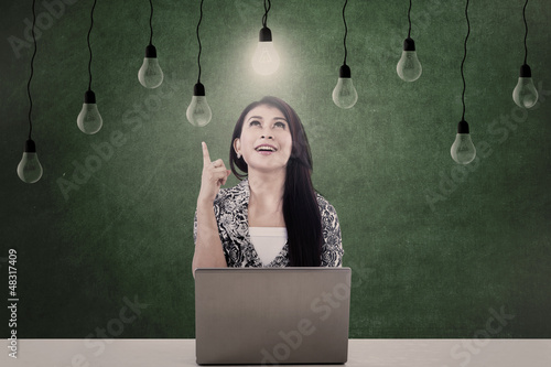 Photo: Bright light bulb and woman Bright light bulb and woman