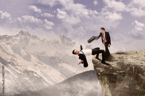 Photo: Business battle on top of cliff Business battle on top of cliff