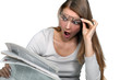 Woman shocked reading newspaper