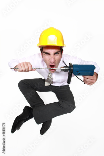 Photo: A mad architect biting a drill. A mad architect biting a drill.