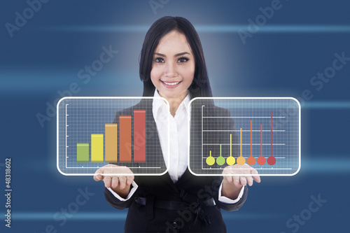 Photo: Businesswoman shows virtual diagrams Businesswoman shows virtual diagrams