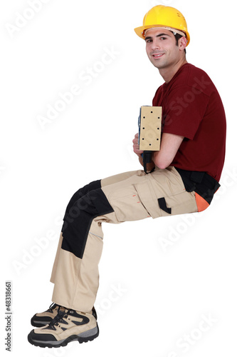 Photo: Carpenter sat with electric sander Carpenter sat with electric sander