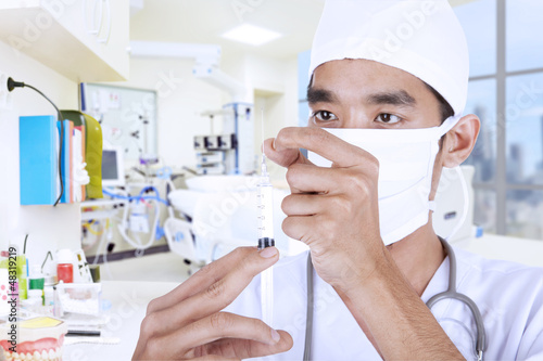 Photo: Doctor giving injection at hospital Doctor giving injection at hospital