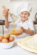 Little girl beating eggs