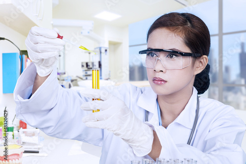 Photo: Scientist and yellow flask Scientist and yellow flask