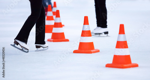 Photo: Red white striped cones on the ice rink Red white striped cones on the ice rink