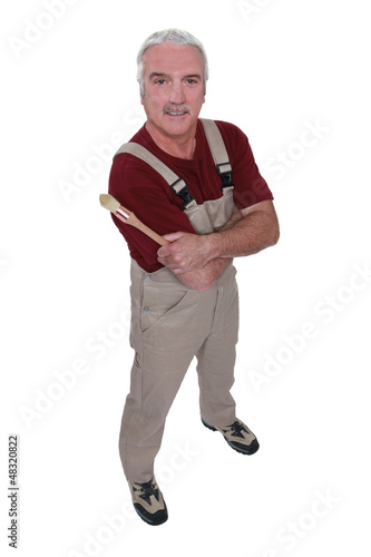 Photo: Experienced decorator stood with his arms folded Experienced decorator stood with his arms folded