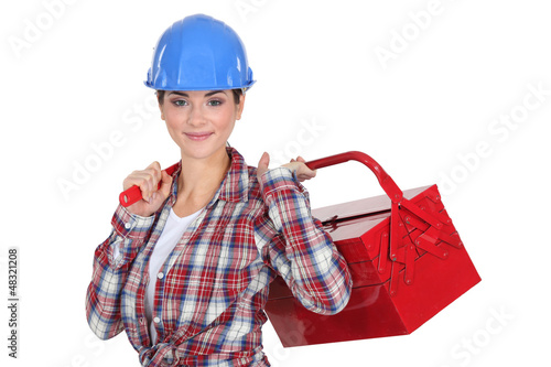 Photo: A handywoman holding a toolbox. A handywoman holding a toolbox.