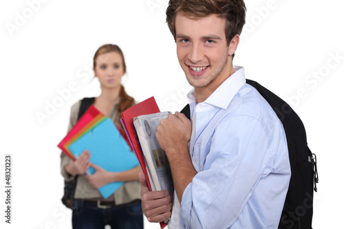 Photo: self-confident student and sad girl in background self-confident student and sad girl in background