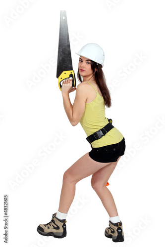 Photo: Woman holding saw provocatively Woman holding saw provocatively