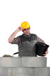 Man laying a blocks wall