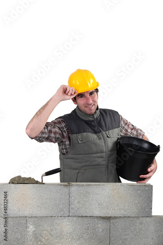 Photo: Man laying a blocks wall Man laying a blocks wall