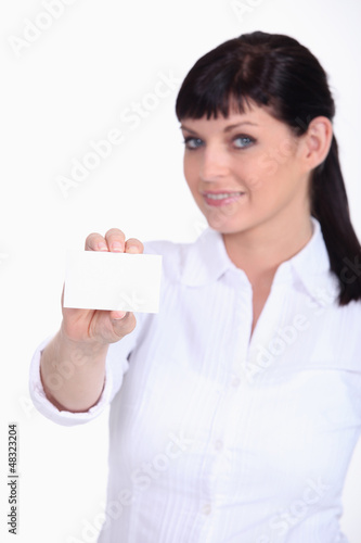 Photo: Woman displaying a business card Woman displaying a business card