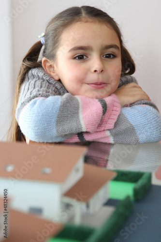 Photo: little girl in a real estate agency little girl in a real estate agency