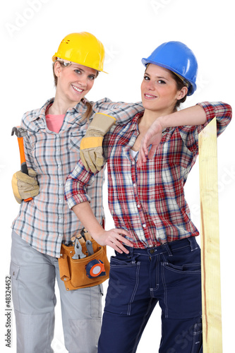 Photo: Two young women laborers in workwear Two young women laborers in workwear
