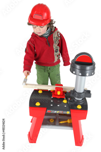 Photo: Young child pretending to be a carpenter Young child pretending to be a carpenter