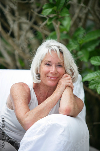 Photo: Senior woman sitting on an outdoor sofa Senior woman sitting on an outdoor sofa