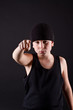 boy in black hat points the finger