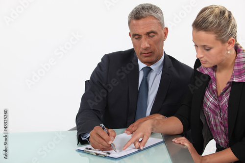 Photo: businessman and assistant examining a project businessman and assistant examining a project