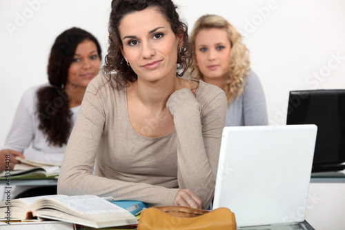 Photo: Three female students studying with their laptops. Three female students studying with their laptops.