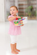 cute little girl holding box of toy