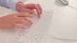 young woman typing on a keyboard