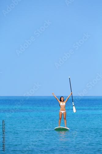 Photo: Aspirational beach lifestyle woman on paddleboard Aspirational beach lifestyle woman on paddleboard