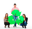 Three people holding a recycle sign