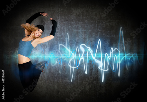 Photo: Woman jumping/dancing to the music rhythm Woman jumping/dancing to the music rhythm