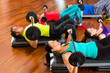 weight training in the gym with dumbbells