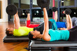 weight training in the gym with dumbbells
