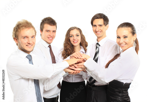 Photo: business team putting their hands on top business team putting their hands on top