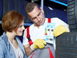 Motor mechanic explains to a customer tire labeling in a garage