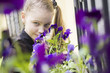 young girl sniffing beautifull flowers