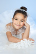 Beautiful little dancer, ballerina in white dress over blue