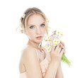 Beautiful blond girl with colorful daisies
