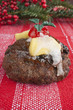 Photo: Christmas pudding with icing, marzipan and red cherry. Christmas pudding with icing, marzipan and red cherry.