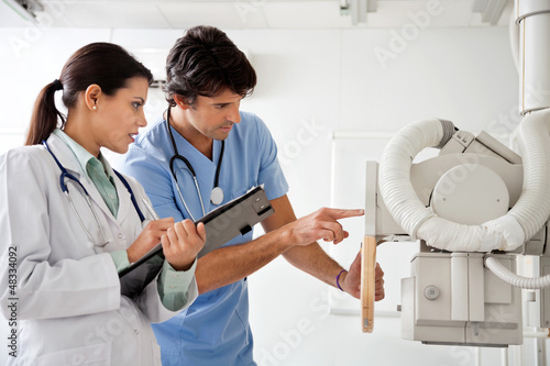 Photo: Radiologist And Technician Working At Clinic Radiologist And Technician Working At Clinic